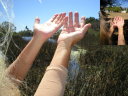 hands lifted up by lake